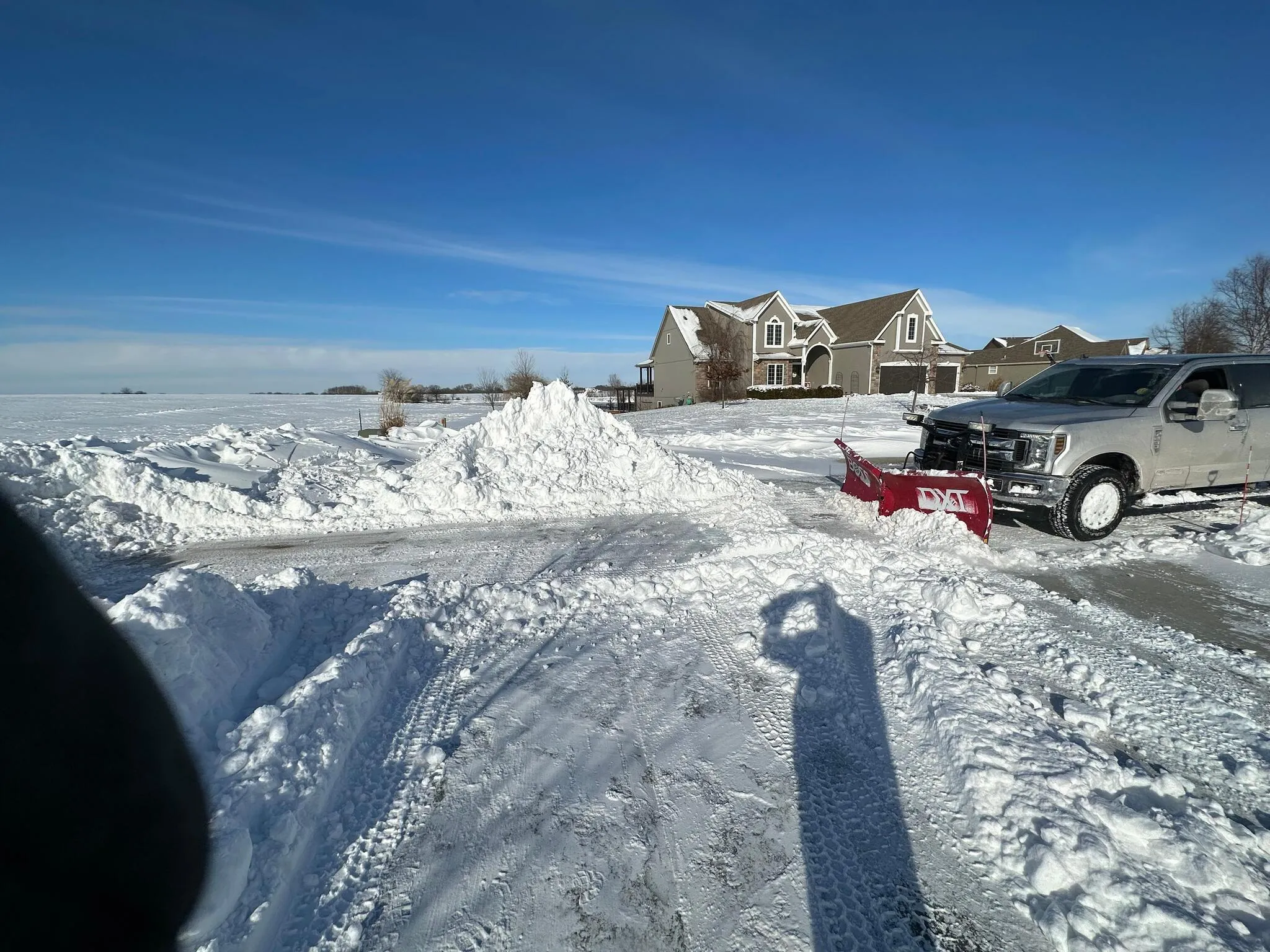 Commercial snow plow clearing a parking lot
