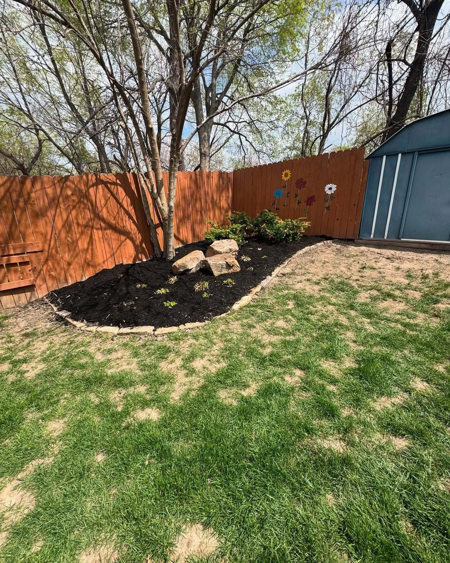 Fresh mulch bed installation during spring cleanup