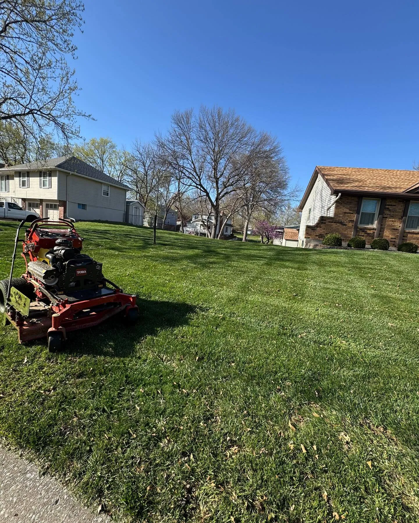 Professional zero-turn lawn mower in action on Kansas City property
