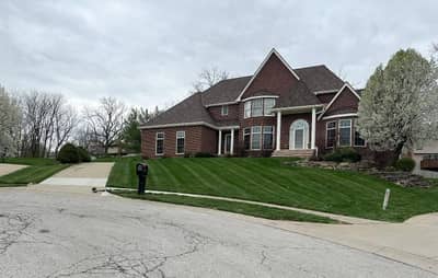 Brick home with well-maintained front lawn